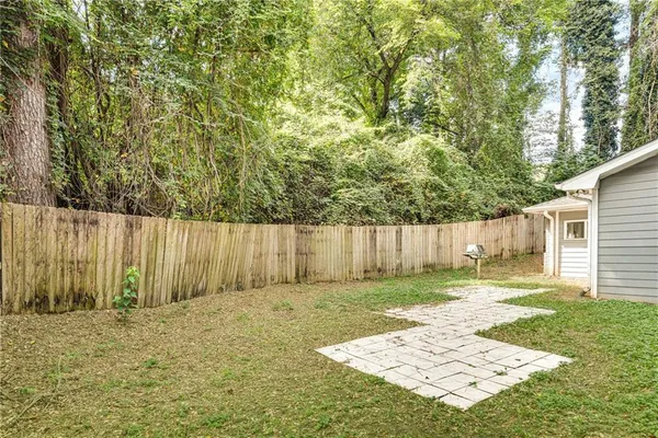 a backyard of a house with a tree