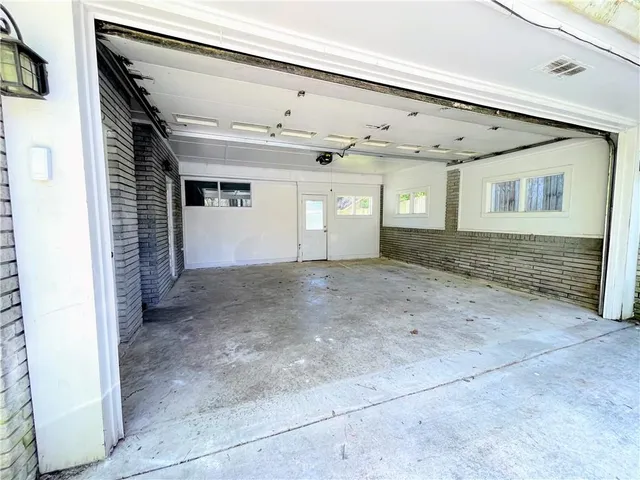 a front view of house and yard with trees