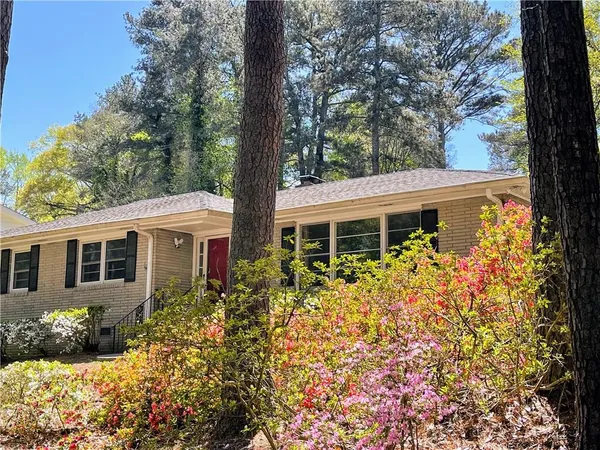 a front view of house and yard with trees