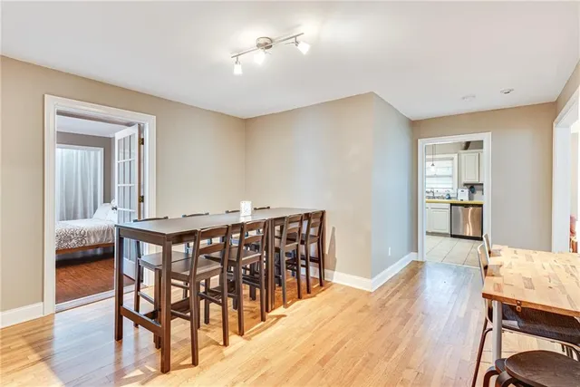 a dining room with furniture and wooden floor