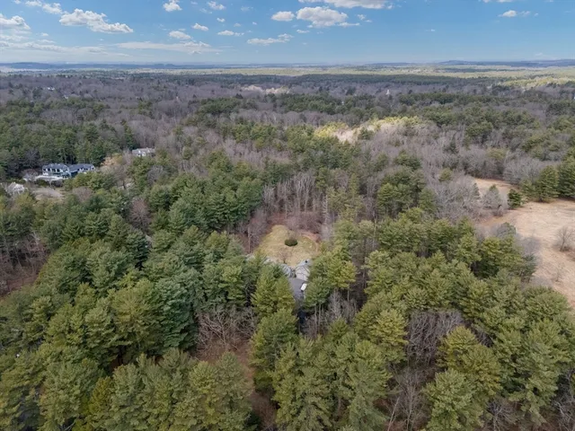 an aerial view of houses with yard and mountain view
