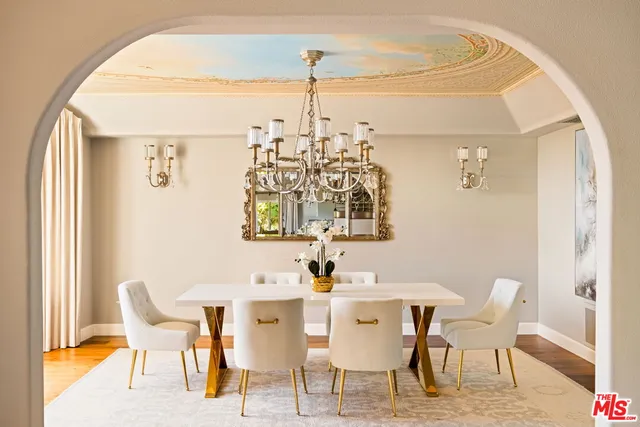 a utility room with stainless steel appliances white cabinets and a sink