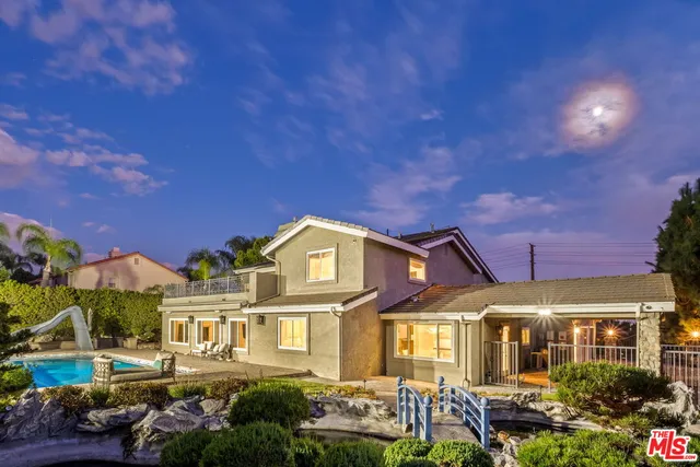 a view of a lush green hillside and a houses