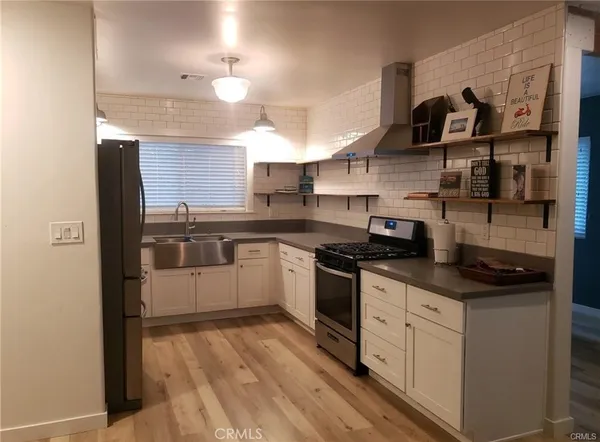 a kitchen with a sink a stove and cabinets