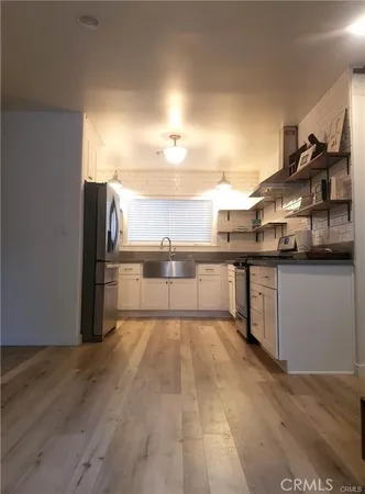 a large kitchen with cabinets and stainless steel appliances