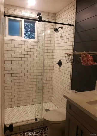 a bathroom with a shower toilet and sink