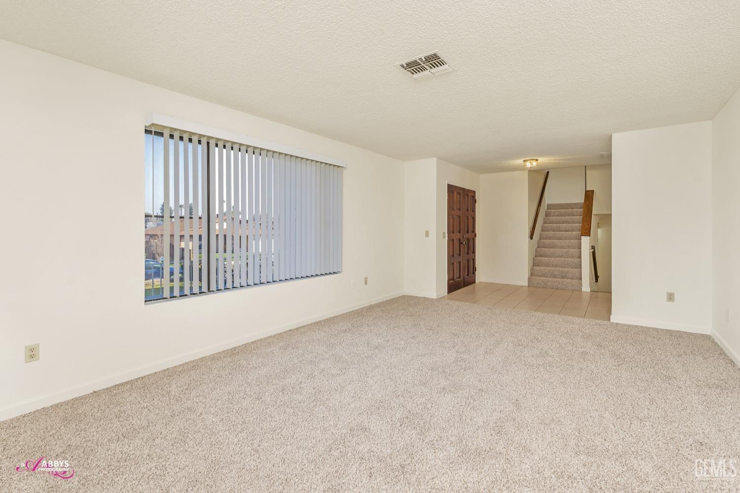 Undisclosed Address Taft, CA 93268 - Photo 11 of 46 Living room with new carpet & vertical blinds
