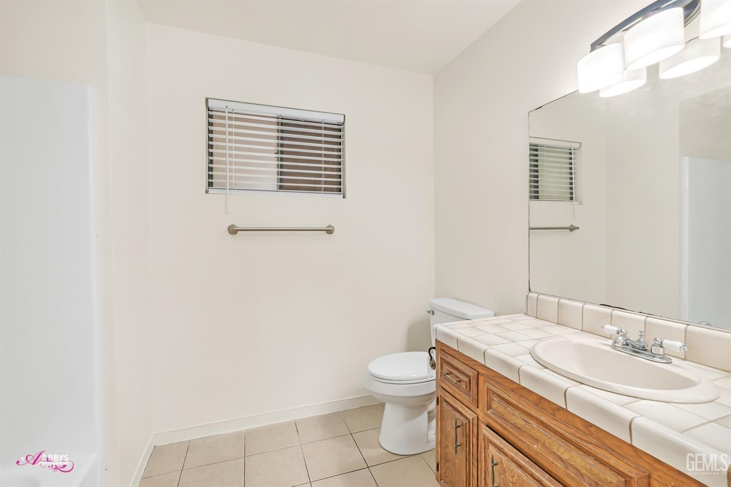 Undisclosed Address Taft, CA 93268 - Photo 30 of 46 Hall upstairs bath with tub/shower; tiled counter & floor; new toilet