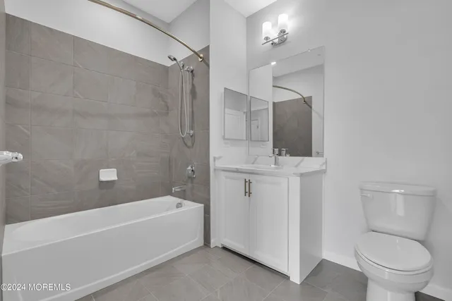 a bathroom with a granite countertop toilet a sink and bathtub