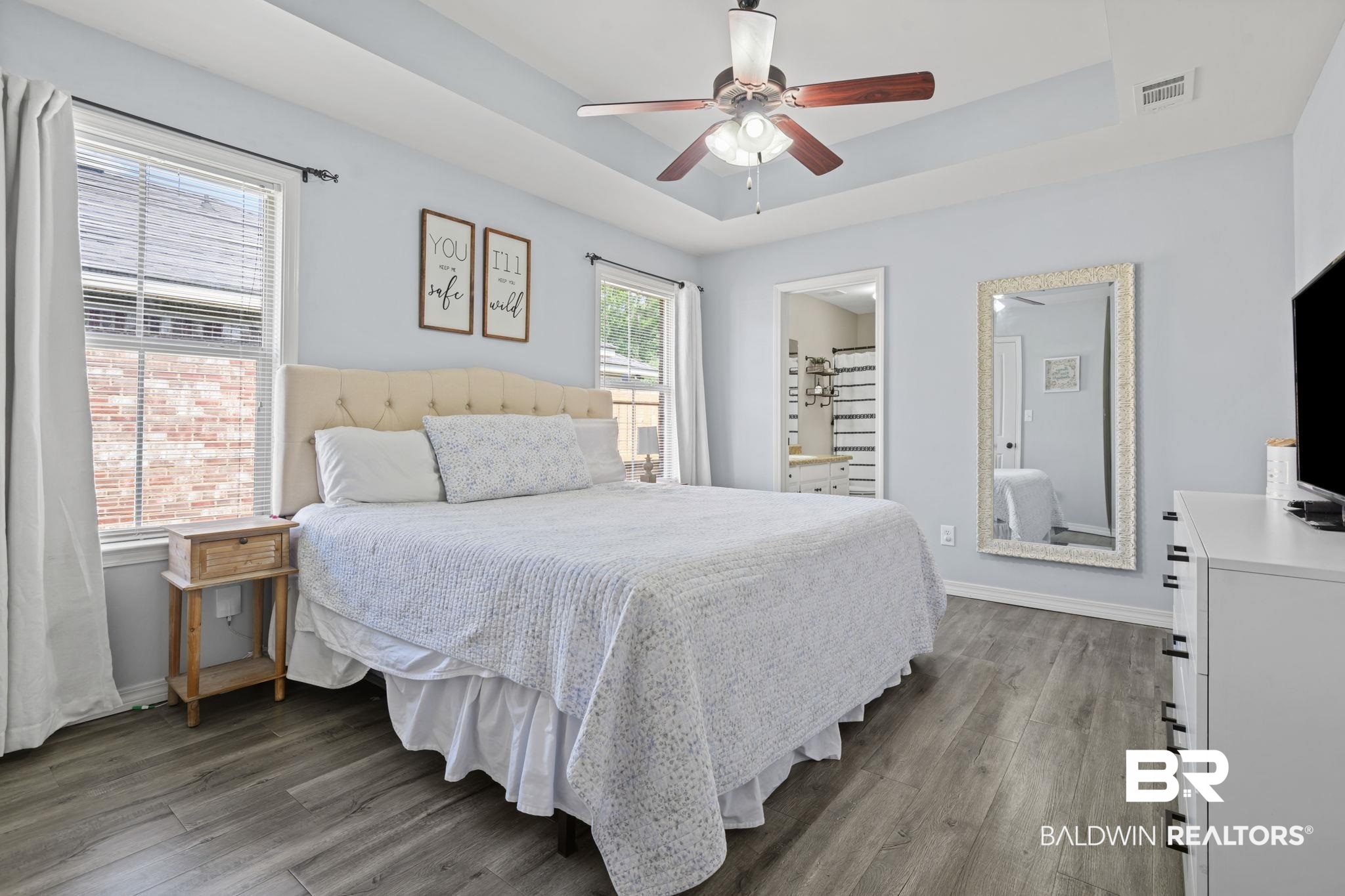 8956 Spring Grove North Mobile, AL 36695 - Photo 9 of 19 Bedroom with a tray ceiling, dark wood-type flooring, baseboards, and a ceiling fan