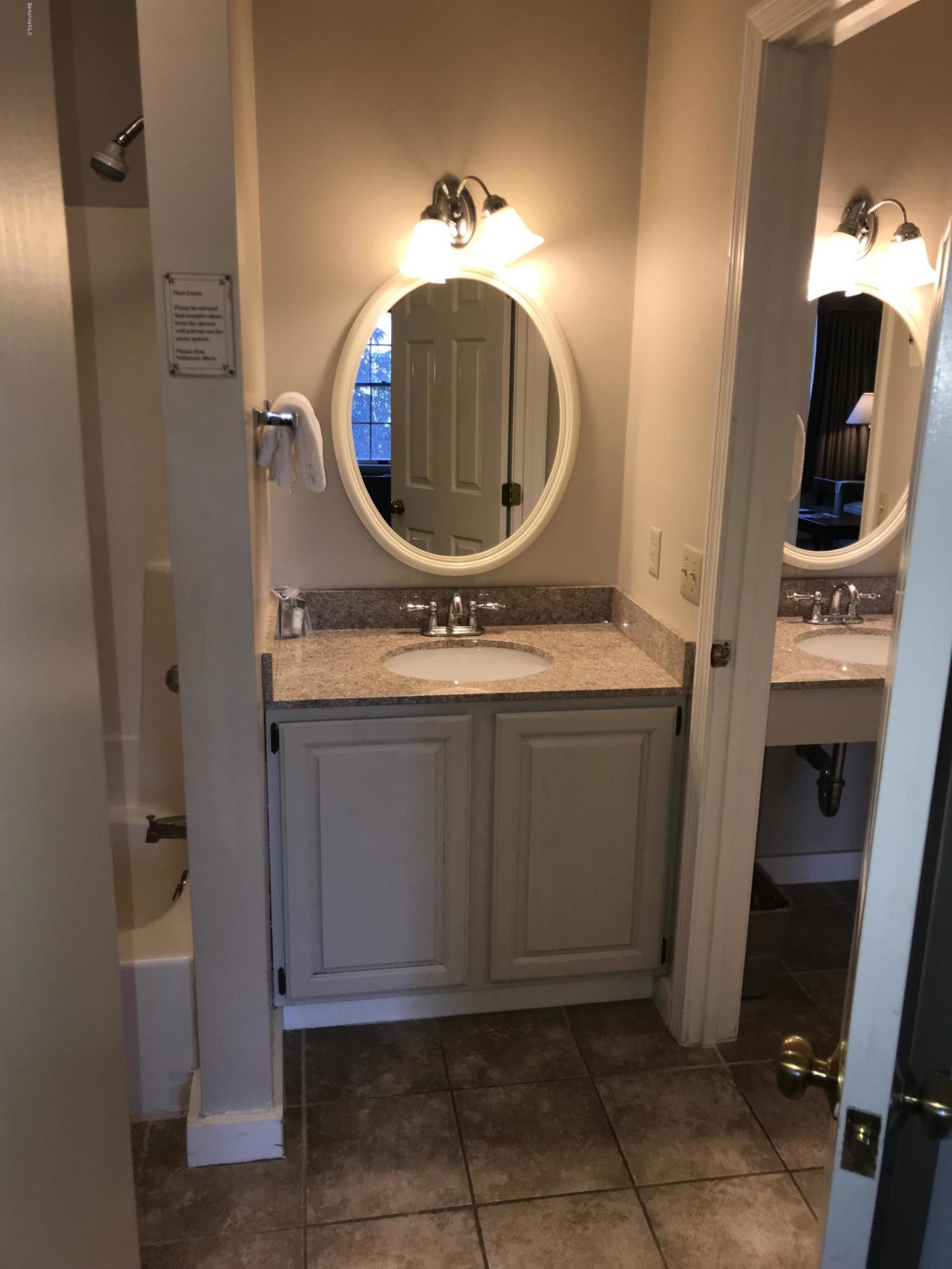 37 Corey Road, Unit 514 Hancock, MA 01237 - Photo 14 of 18 a bathroom with a mirror and a sink