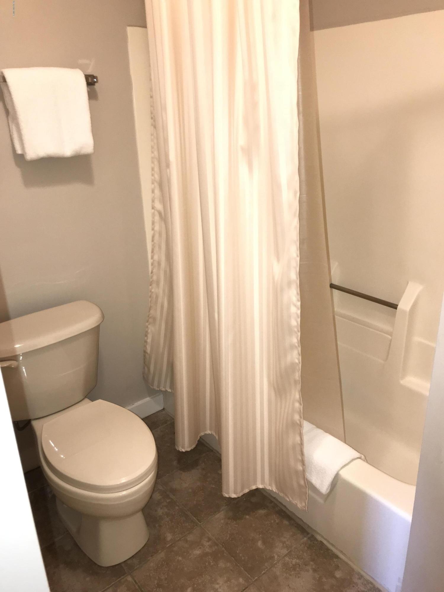 37 Corey Road, Unit 514 Hancock, MA 01237 - Photo 15 of 18 a white toilet sitting next to a shower curtain