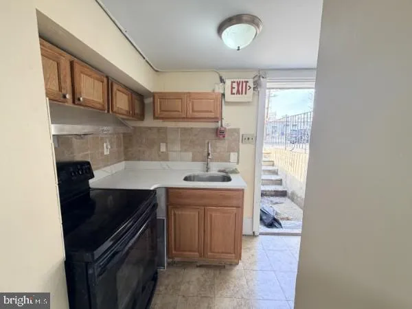 a kitchen with a stove and a refrigerator