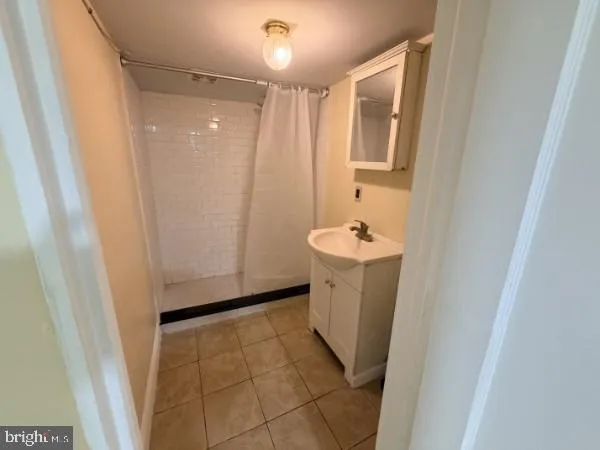 a bathroom with a sink a mirror and a shower