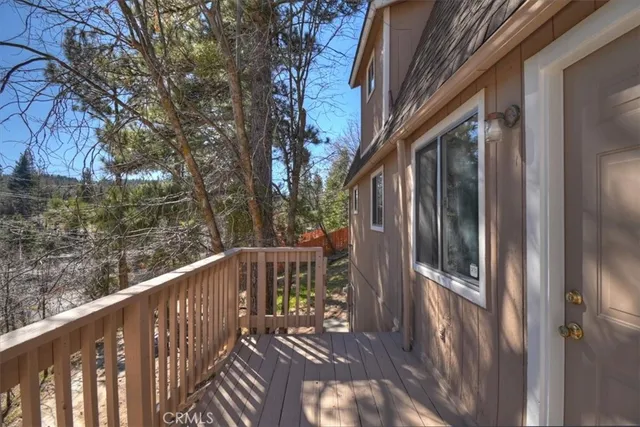 a view of balcony with wooden floor and fence