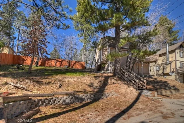 a view of a yard with large trees