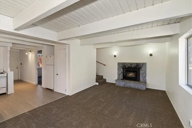 a view of an empty room and fire place