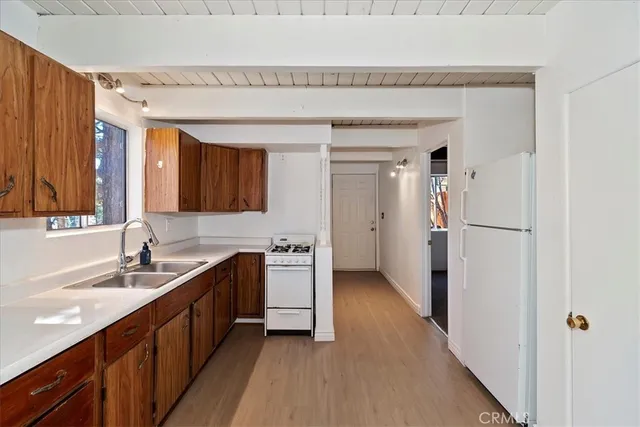 a kitchen with a sink and a refrigerator