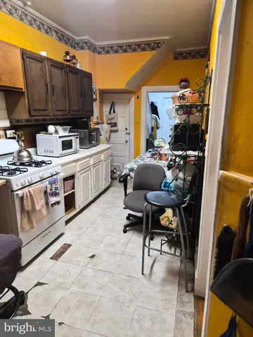 a kitchen with stainless steel appliances kitchen island granite countertop a stove a sink and a microwave