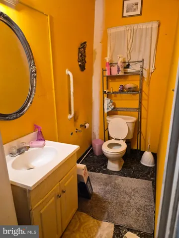 a bathroom with a sink toilet and a mirror