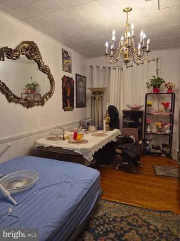 a bedroom with a bed dresser and flat screen tv