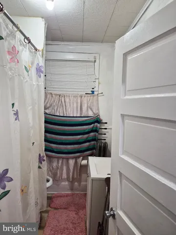 a view of entryway with wooden cabinet