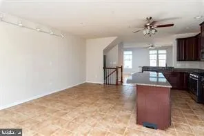 a view of a kitchen with a sink and a chandelier fan