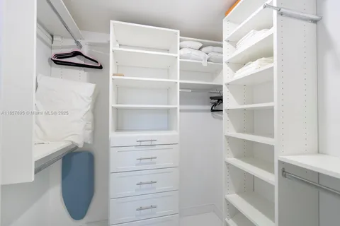 a view of walk in closet with empty racks