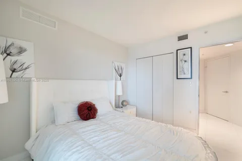 a bedroom with a bed and lamp