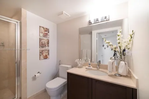 a bathroom with a sink toilet and a mirror
