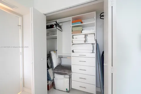 a view of walk in closet and bedroom