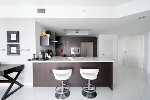 a kitchen with a table and chairs in it