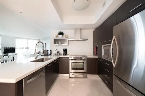 a kitchen with cabinets stainless steel appliances a sink and a counter top space