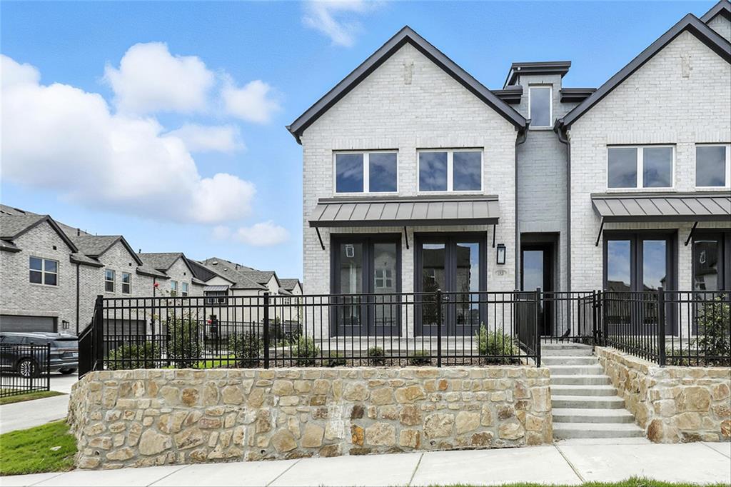 a view of a brick house with many windows