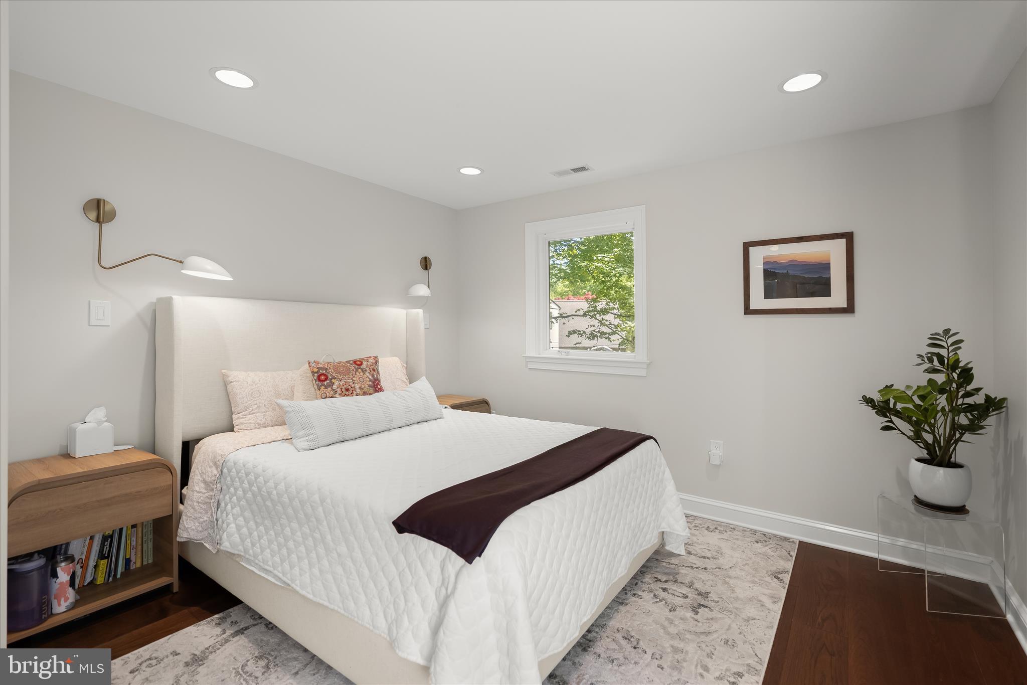 6366 11th Road North Arlington, VA 22205 - Photo 17 of 39 a bedroom with a bed and a potted plant