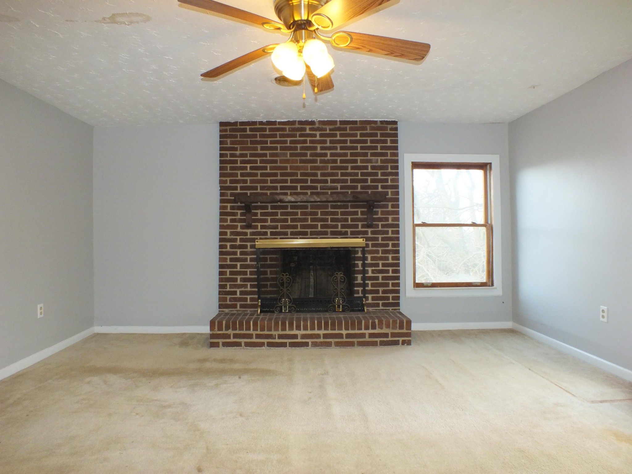 2559 Niles Ferry Road Greenback, TN 37742 - Photo 8 of 29 an empty room with a fireplace and window