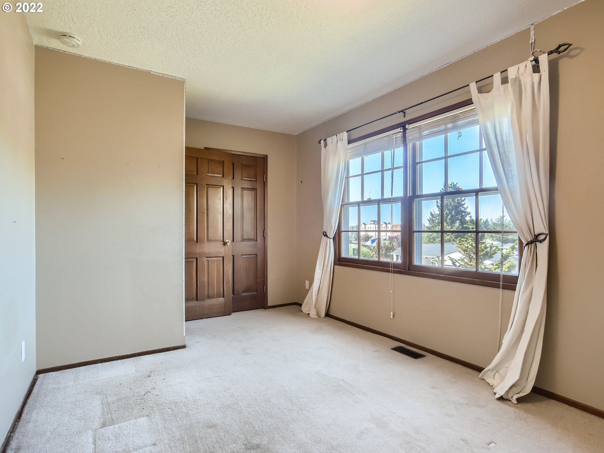 10920 Southeast Clay Street Portland, OR 97216 - Photo 17 of 30 a view of an empty room with a window