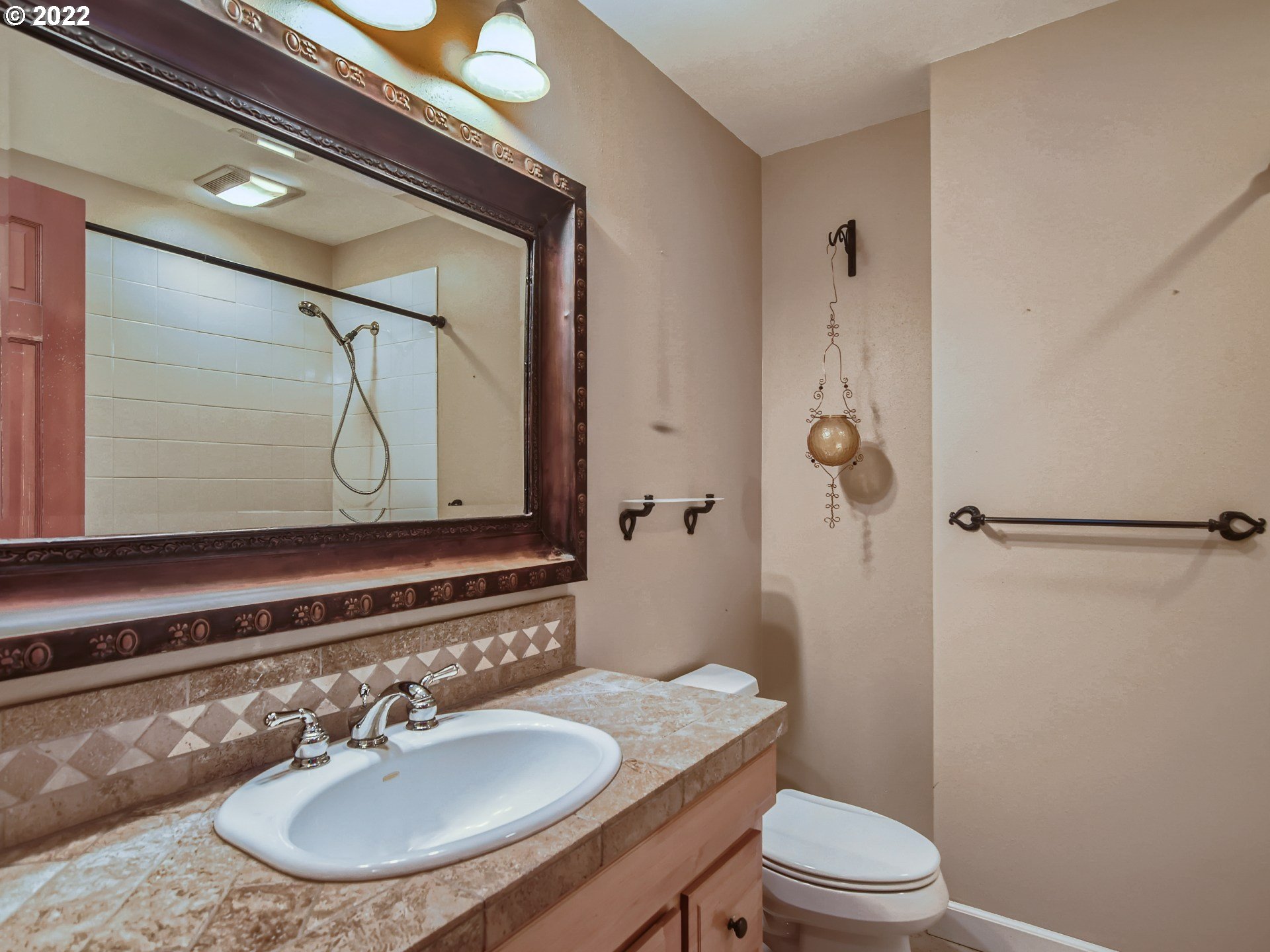 10920 Southeast Clay Street Portland, OR 97216 - Photo 18 of 30 a bathroom with a toilet a sink and mirror