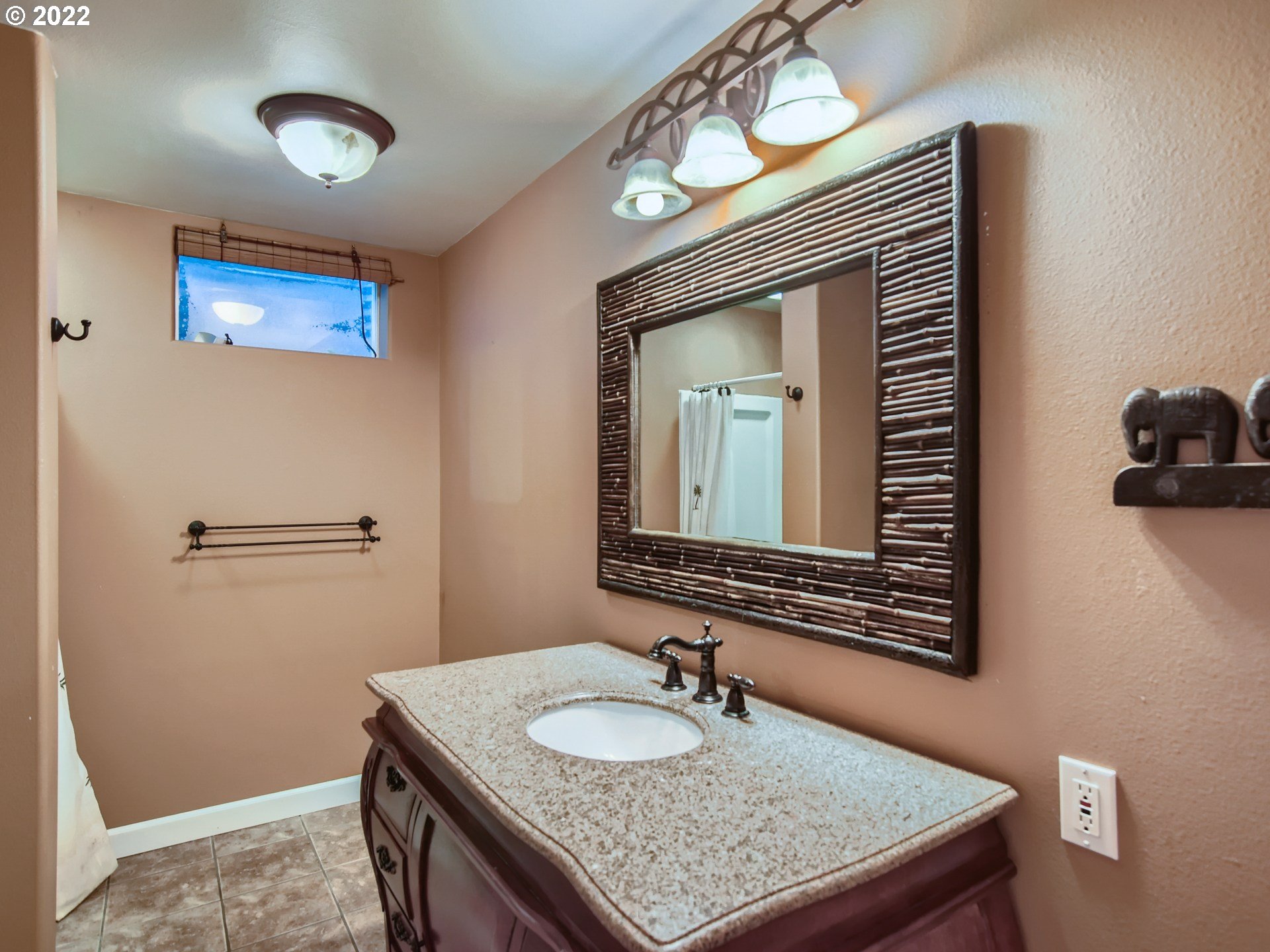 10920 Southeast Clay Street Portland, OR 97216 - Photo 23 of 30 a bathroom with a granite countertop sink a mirror and vanity