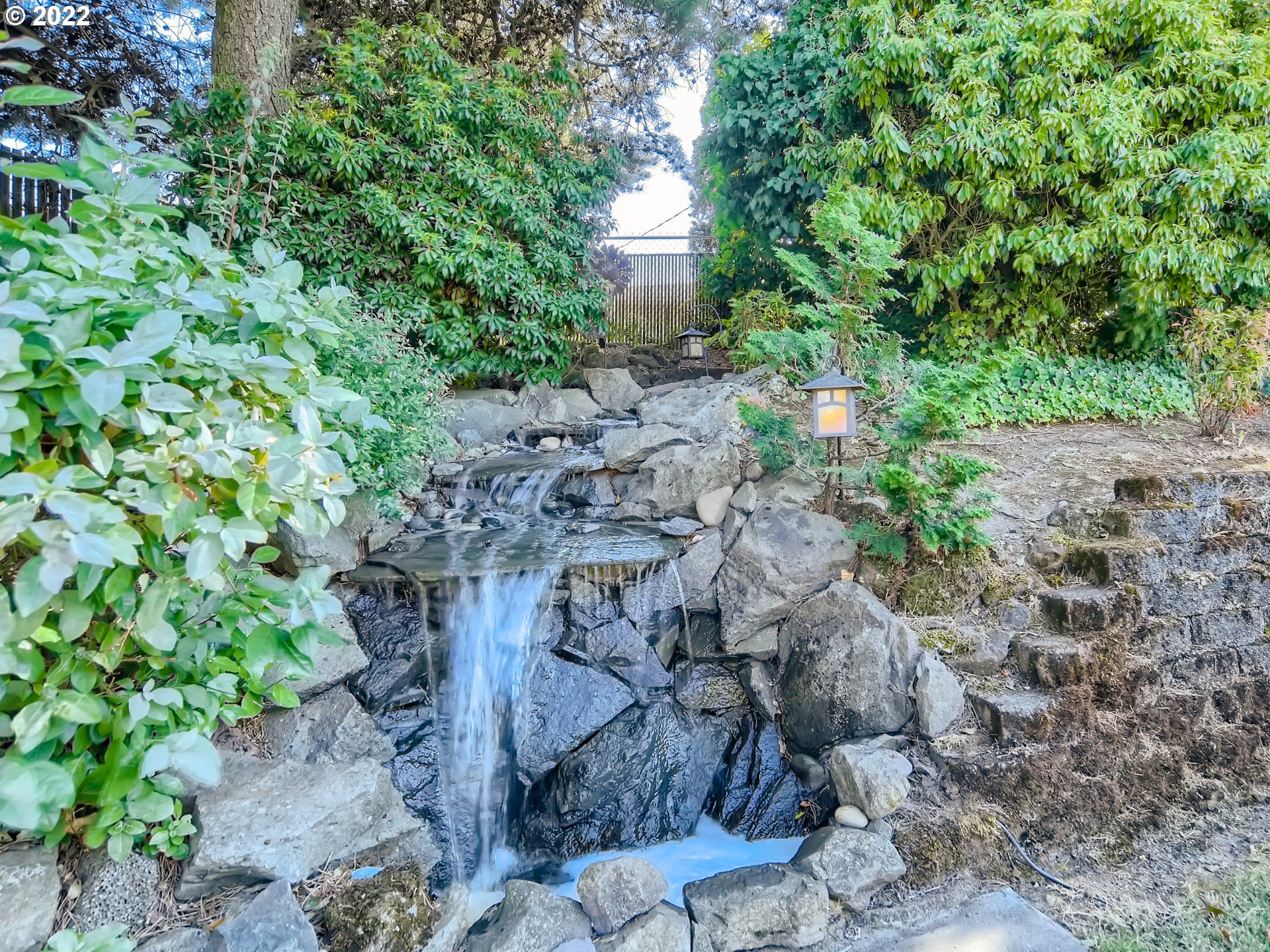 10920 Southeast Clay Street Portland, OR 97216 - Photo 27 of 30 a view of a garden with a fountain