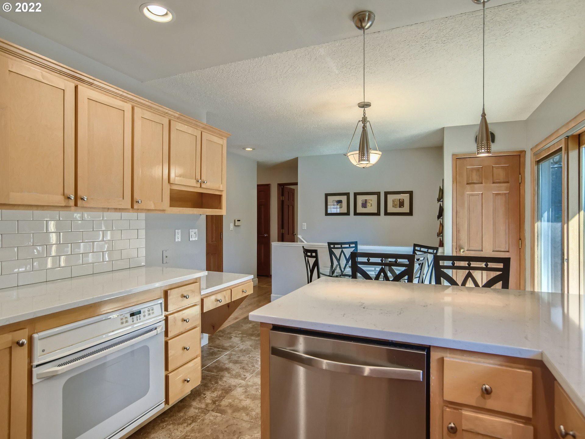 10920 Southeast Clay Street Portland, OR 97216 - Photo 10 of 30 a kitchen with stainless steel appliances granite countertop a sink a stove and a refrigerator