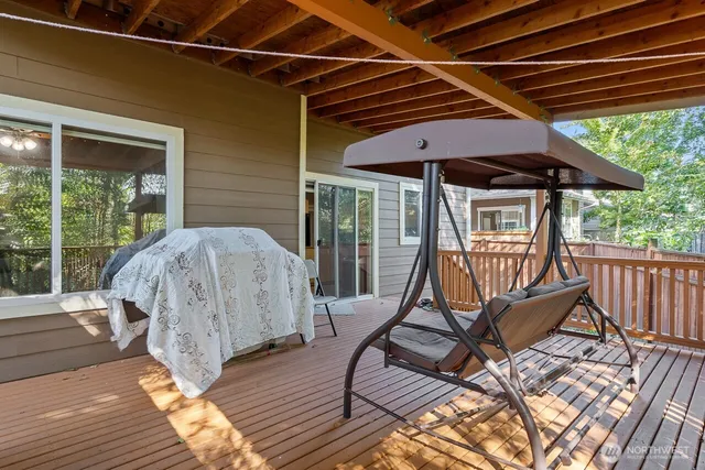 a view of a roof deck with chair and wooden floor