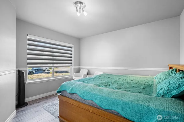 a living room with a bed furniture and a window