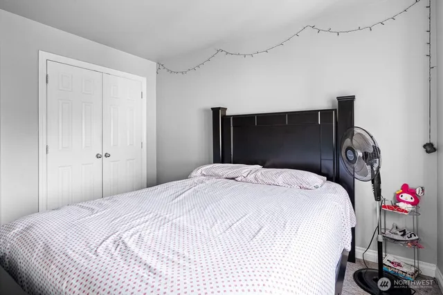 a bedroom with a bed and a closet