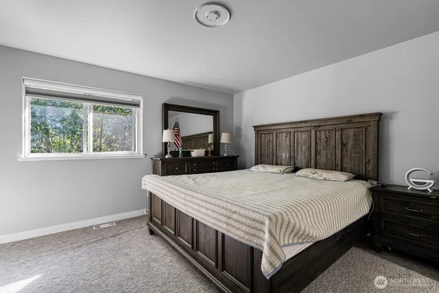 a bedroom with a bed and a dresser