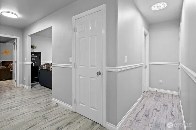 a view of walk in closet with wooden floor