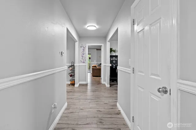 a view of a hallway with wooden floor and staircase