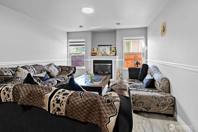 a living room with furniture fireplace and a window