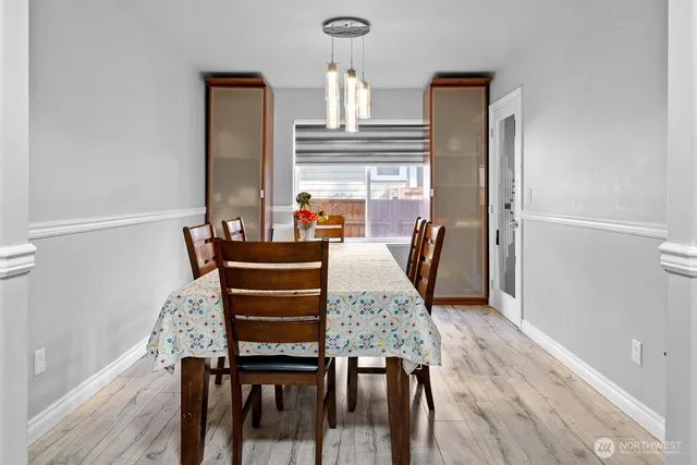 a view of a dining room with furniture and a window