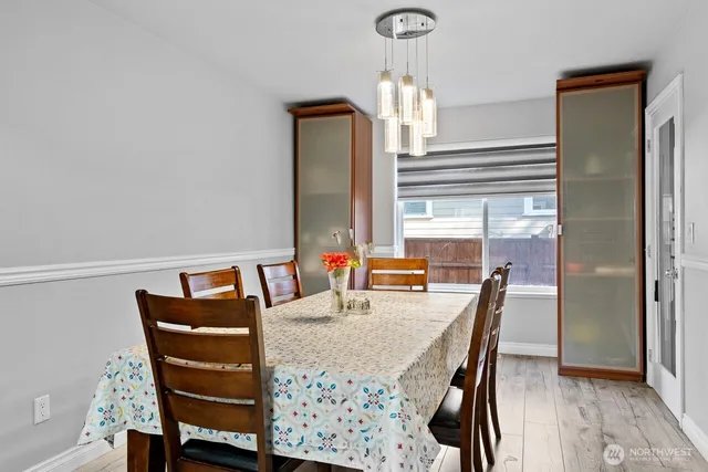a view of a dining room with furniture and a window